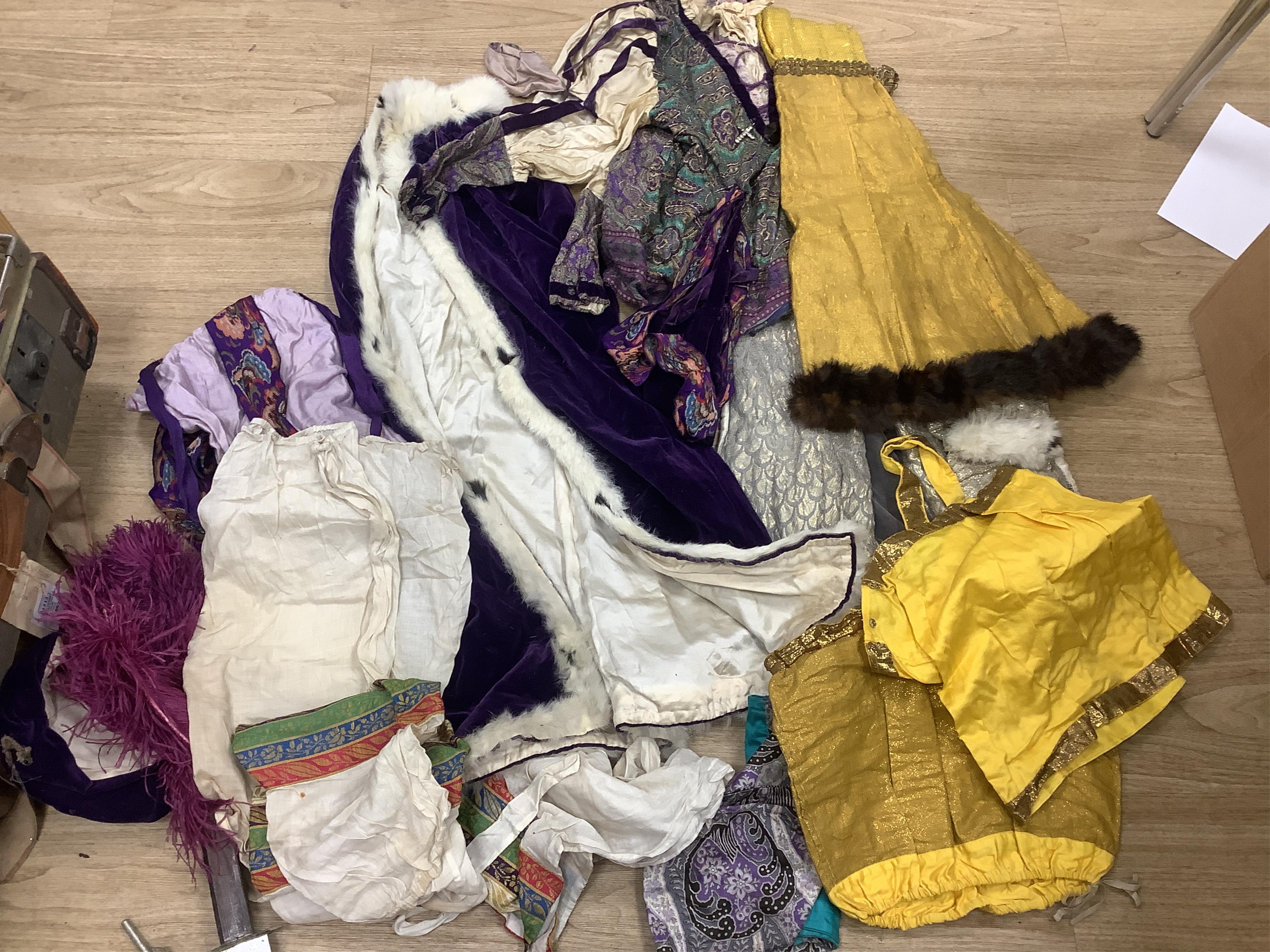 Two trunks containing a collection of children’s fancy dress from early 20th century, including an unusual child’s ‘pearly king’ suit, two earlier stockinette hats, a length of long silver metal fringing, ribboning etc.,